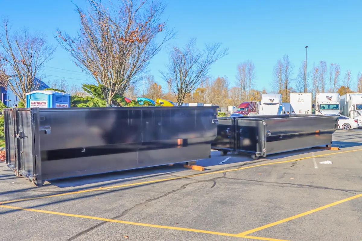 Professional dumpster rental service with roll-off container on residential driveway in San Clemente